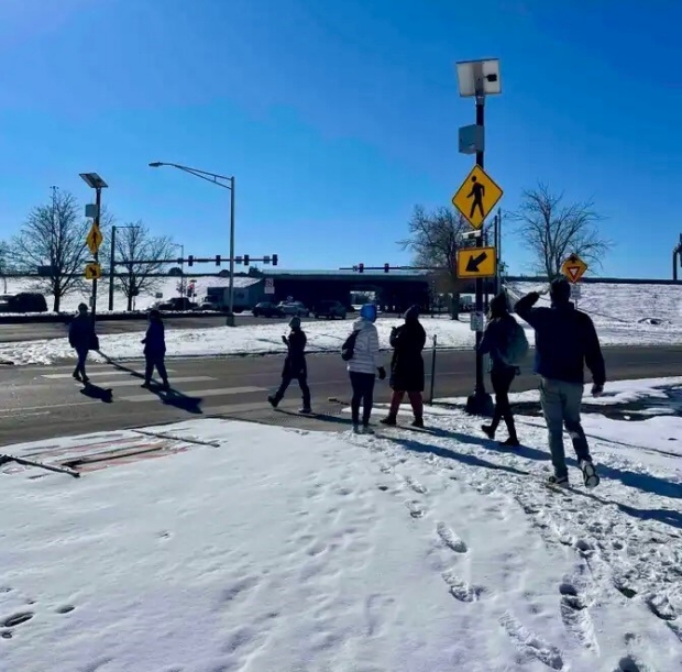 Participants using a crosswalk in the snow